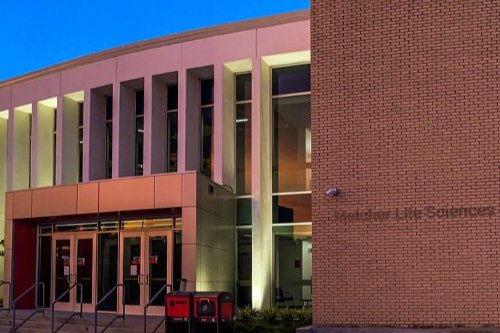 A building with a sign on the front that says Melcher Life Sciences