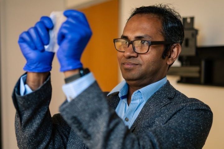 Image of Professor Maksud Rahman holding the bioplastic, made of bacterial cellulose, that could replace plastic.