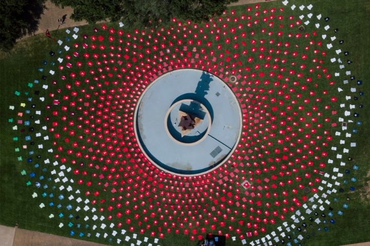 1,001 T-shirts laid out at Butler Plaza. The shirts are red, white and black. 