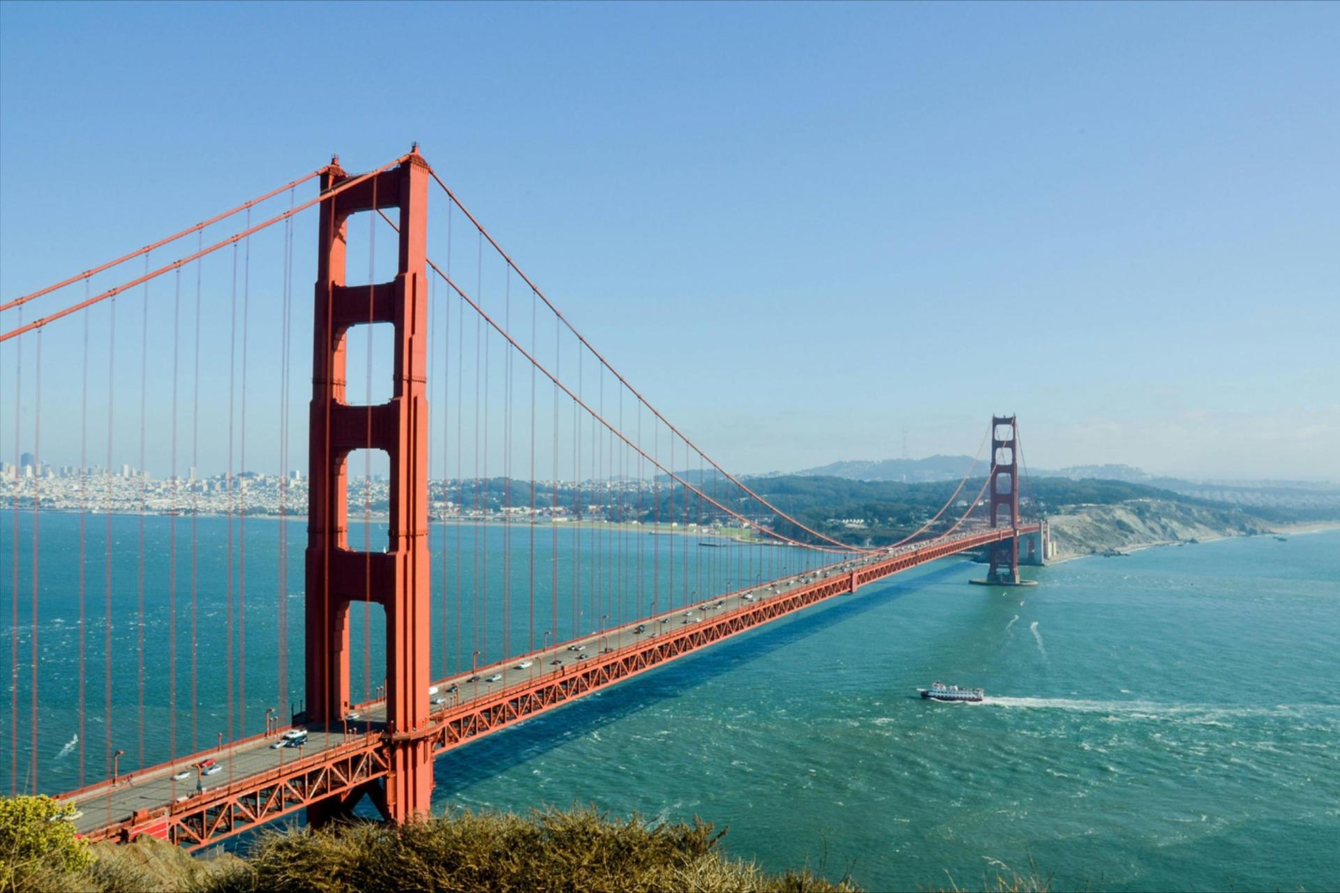 Golden Gate Bridge over water with a boat in the background