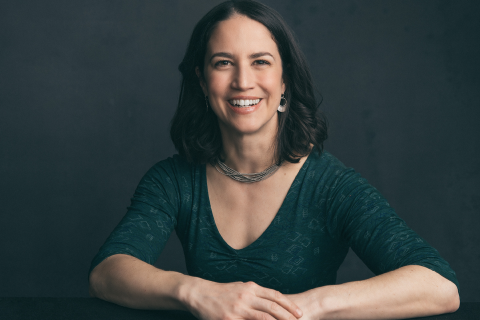 Image of Catherine Price smiling with a gray background behind her.