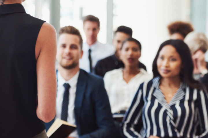 Stock photo of a group of professionals listening and learning.
