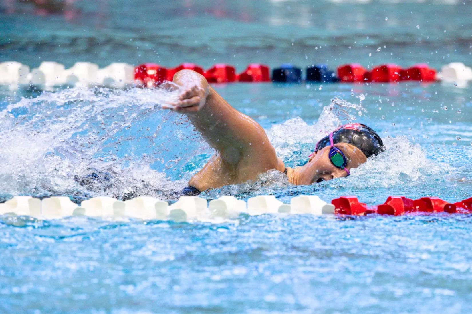 A woman competing in a swimming pool.