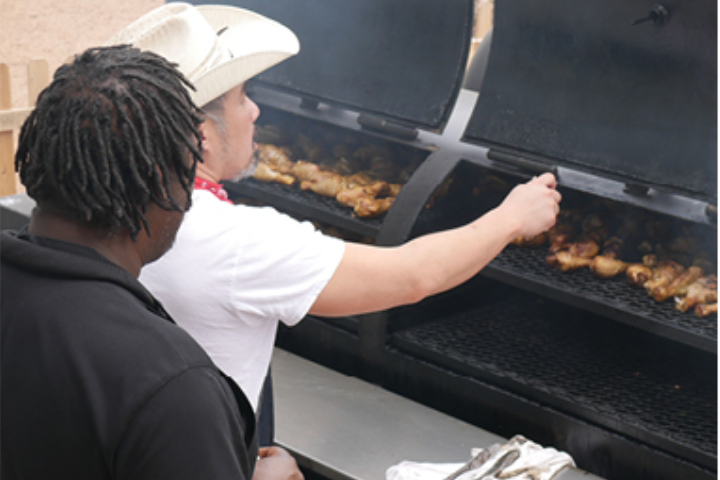 UH dining hall cooks working to cook barbecue for Go Texan Day