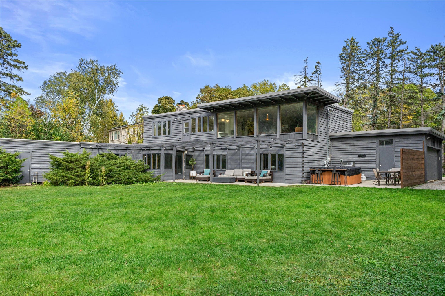 a staircase with glass railings and chandelier