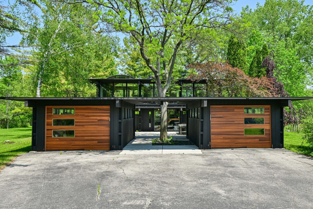 a kitchen with a large island and chandeliers