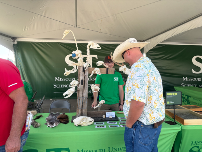 Students talking to state fair attendees. 