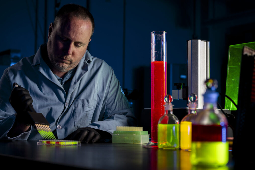 Dr. Anthony Convertine prepares a liquid resin for 3D printing biomaterials used for tissue engineering. Photo by Michael Pierce/Missouri S&T. 