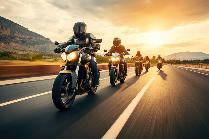 a group of people riding motorcycles on a road