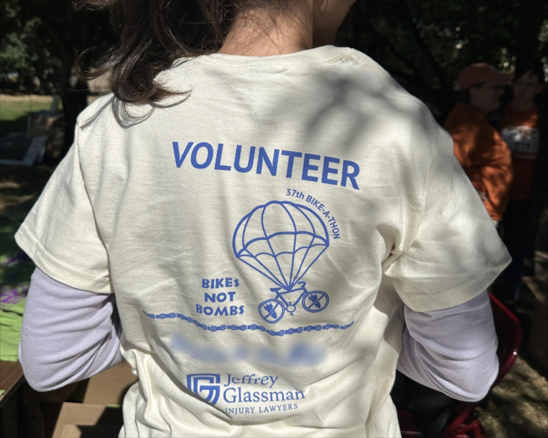 a person wearing a white shirt with blue writing on it