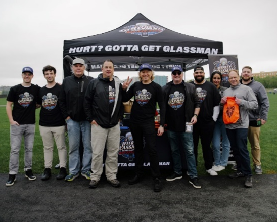 a group of people standing in front of a tent