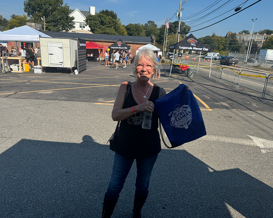a woman holding a water bottle and a bag