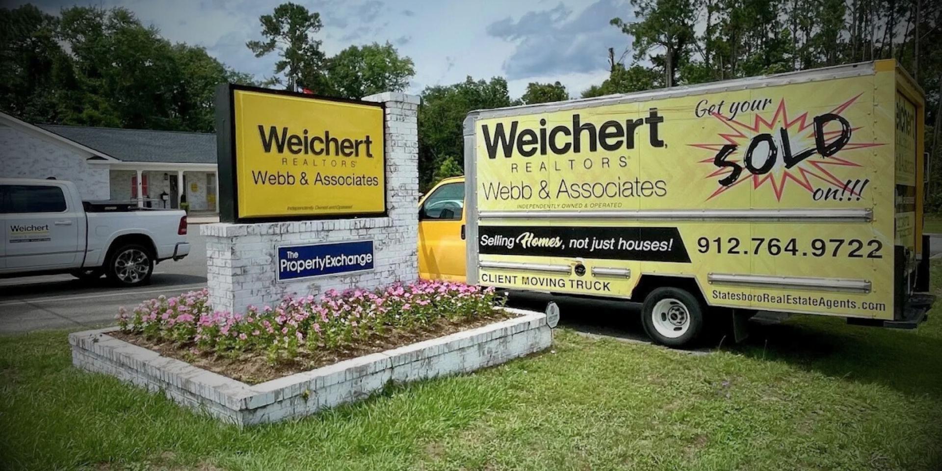 Weichert, Realtors - Webb & Associates office sign and the brokerage's client moving truck