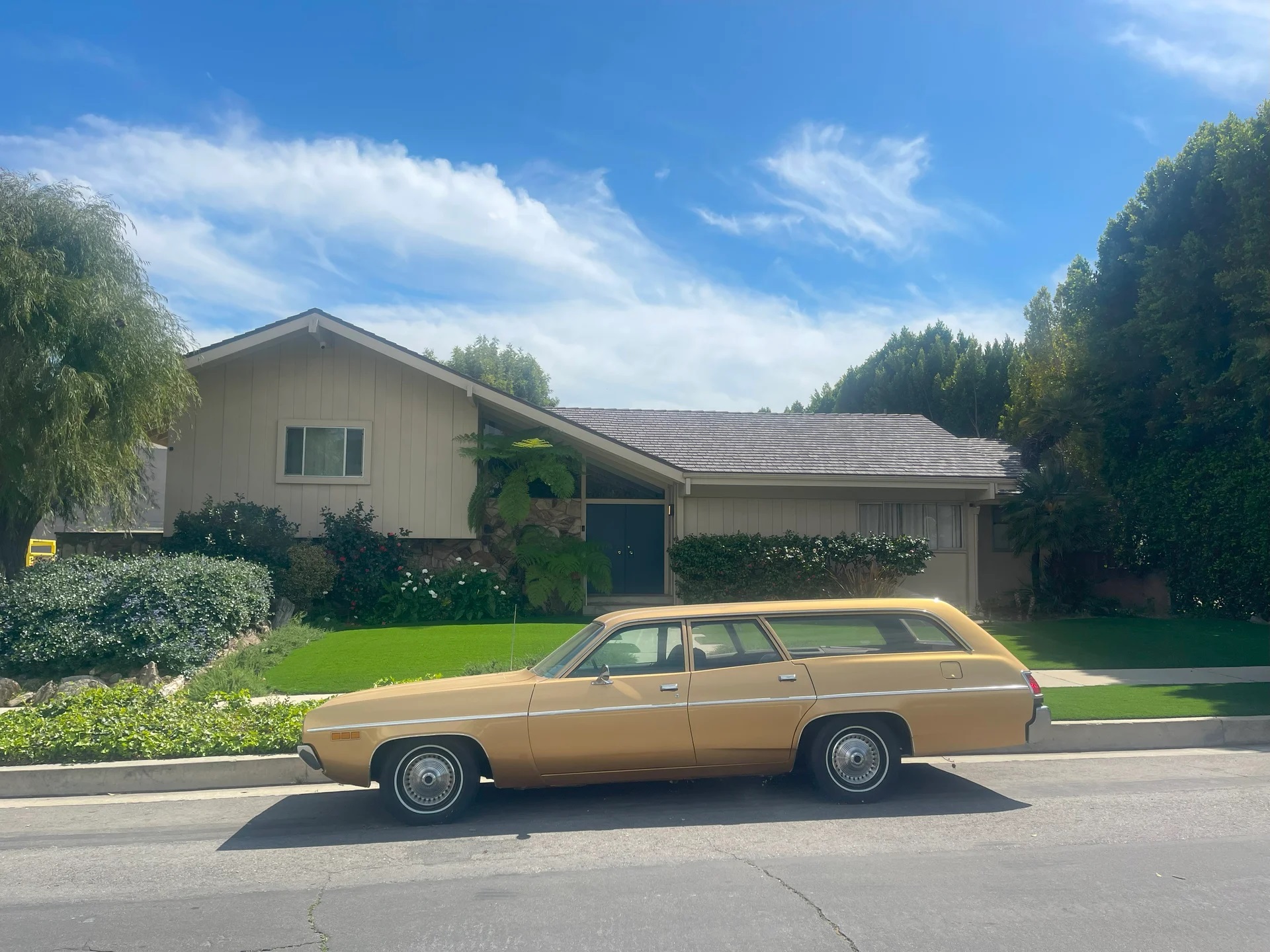 The Brady Bunch house with classic 1970s station wagon parked in front