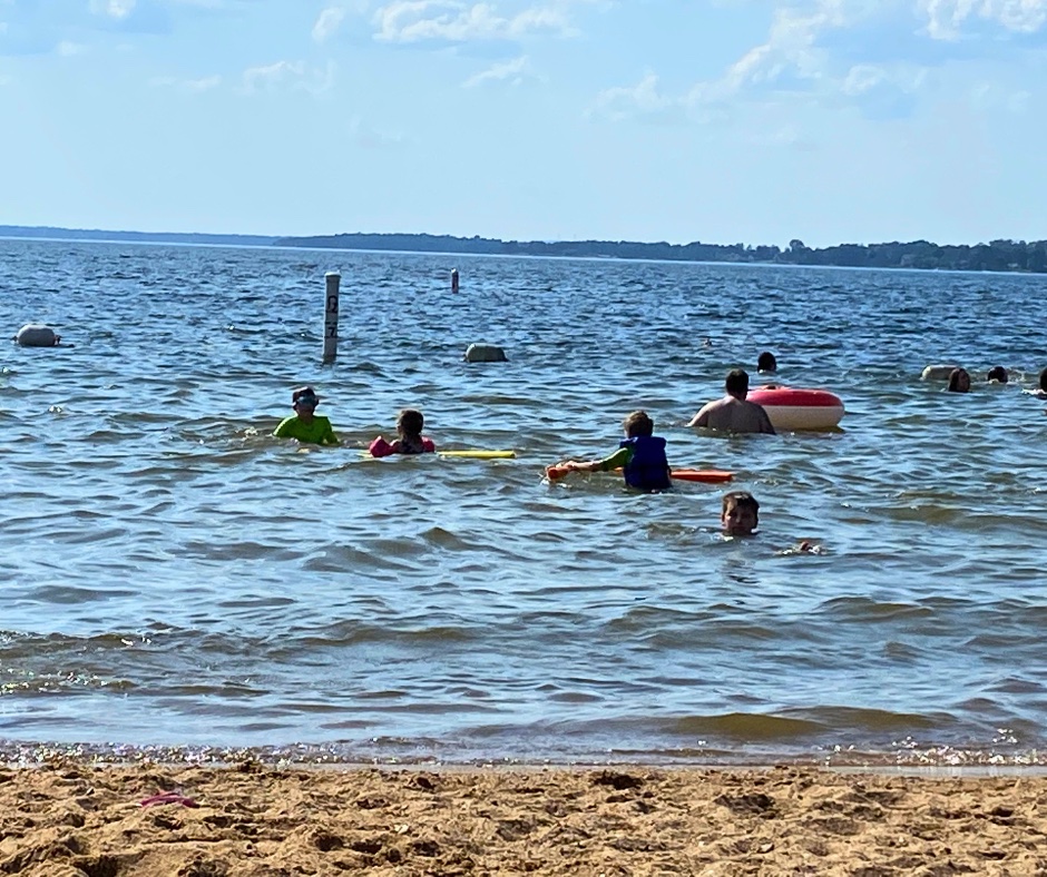 Public beach area near Lake Murray Dam with families swimming