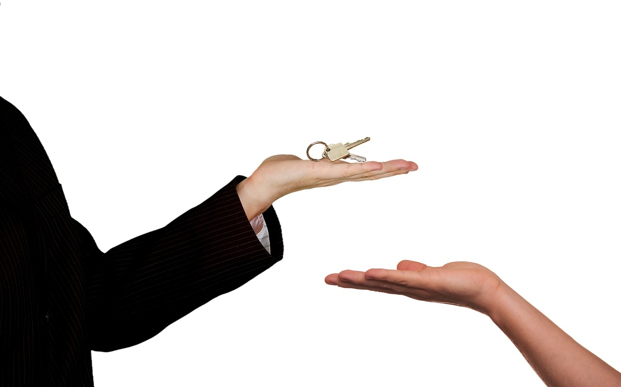 Real estate agent handing over home keys