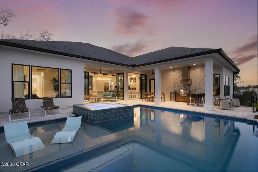 beautiful one story cove home with a massive pool and chairs designed for the water beautiful one story cove home with a massive pool and chairs designed for the water