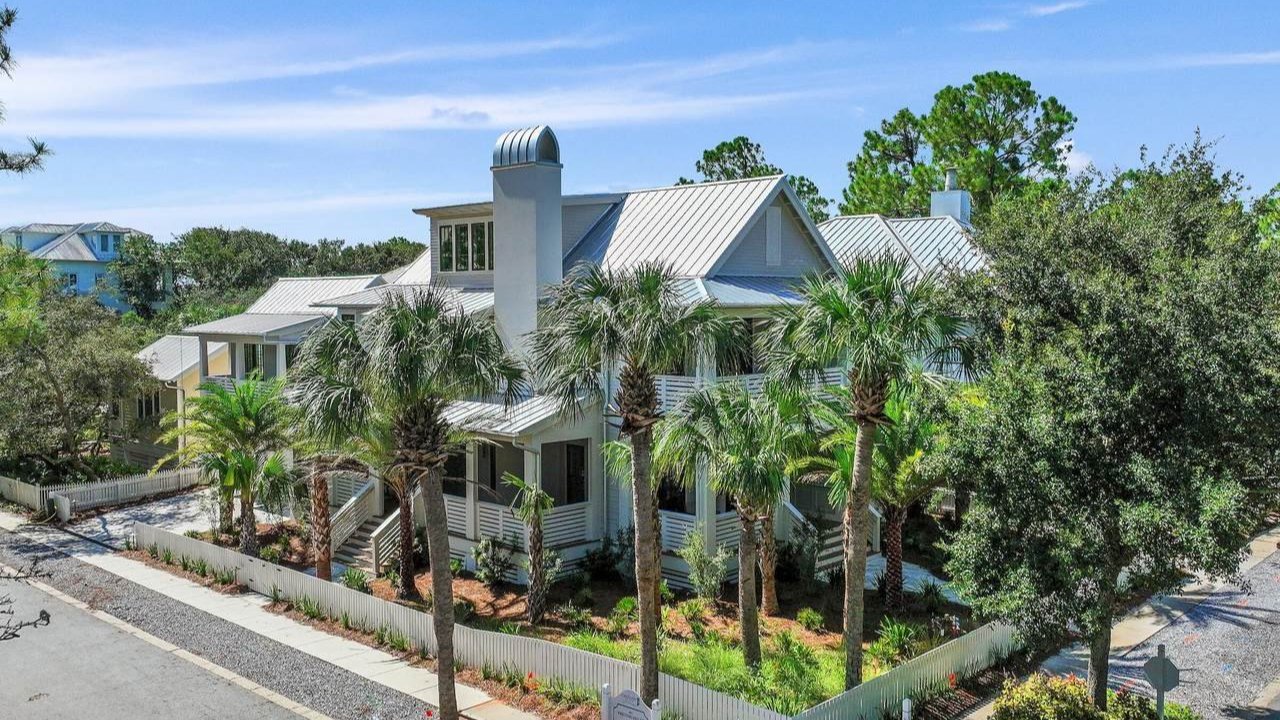 carillon beach home surrounded by various sizes of palm trees