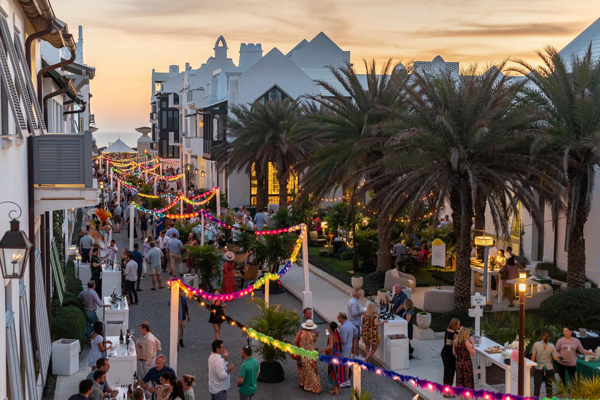 Alys beach homes lined along a street colorfully lit with string lights Alys beach homes lined along a street colorfully lit with string lights