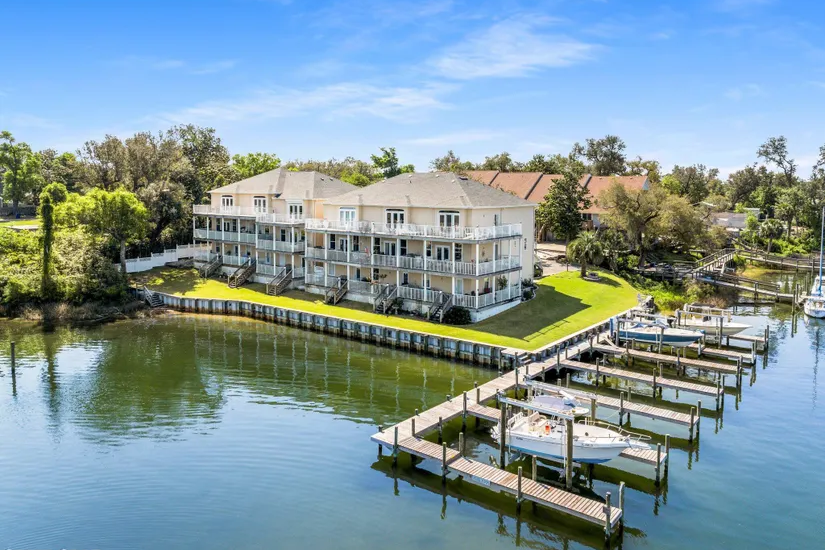 a cove home occupied with a dock having 3 boats stationed a cove home occupied with a dock having 3 boats stationed