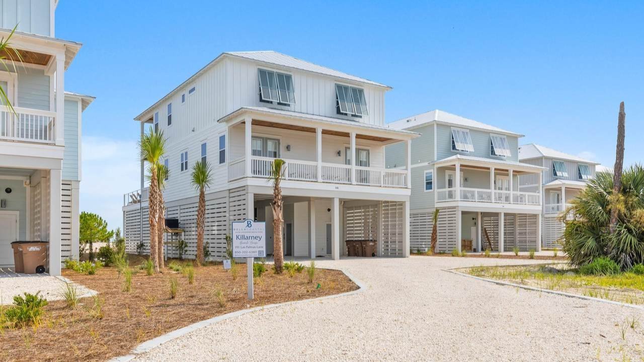 stilt double story cape san blas home growing palm trees and a finished gravel driveway