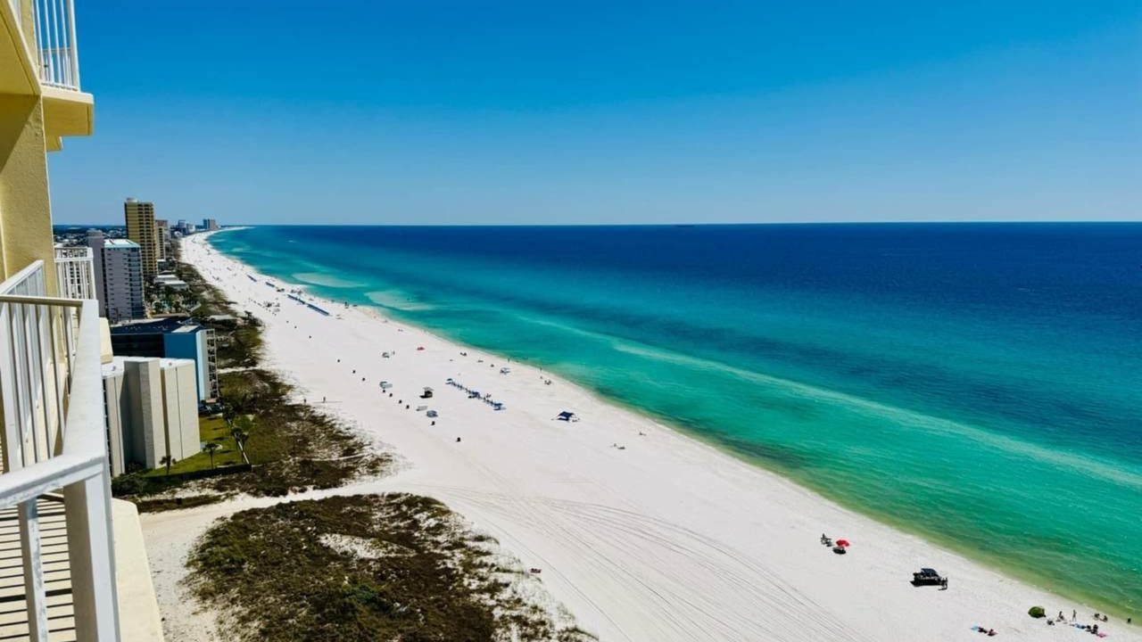 view of the beach from the balcony of a boardwalk beach resort condo