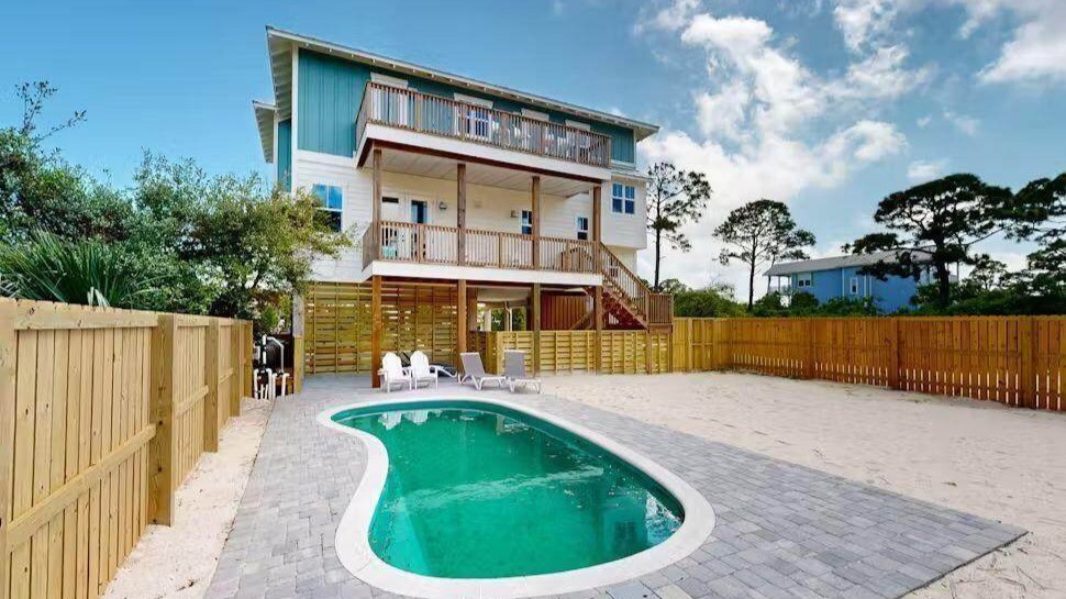stilt double story cape san blas home with a large backyard and tucked in pool in the corner