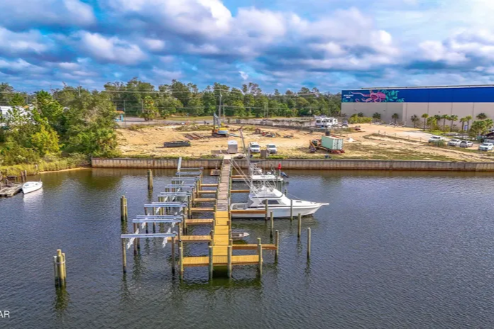 A dock currently under construction for a possible new listing with cove homes in the back A dock currently under construction for a possible new listing with cove homes in the back
