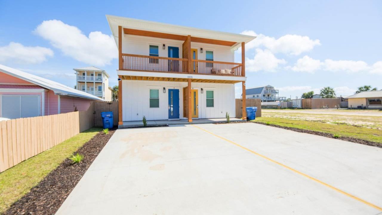 double story holiday beach home with a large driveway
