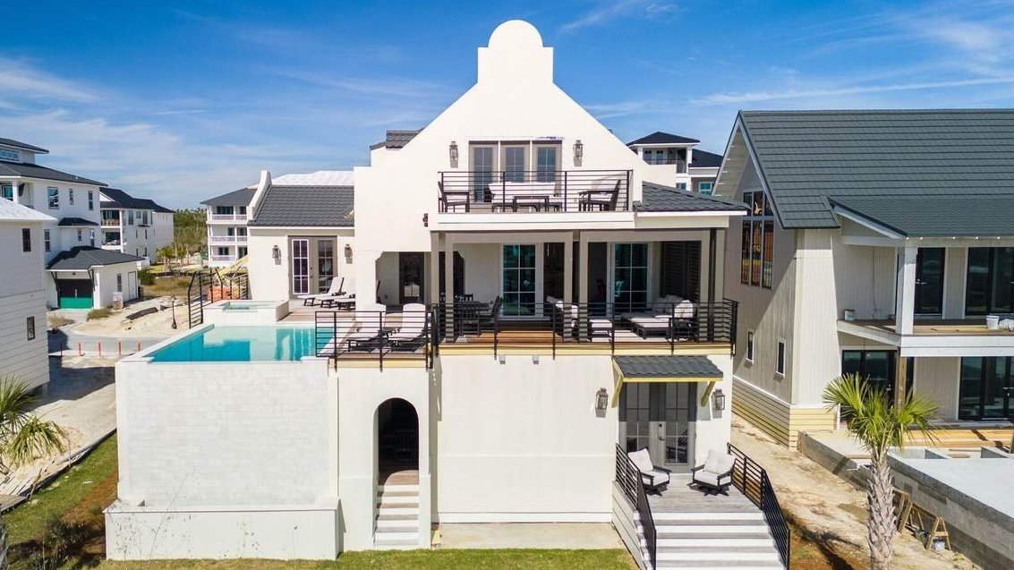 mexico beach home with a pool in the back occupied with other homes