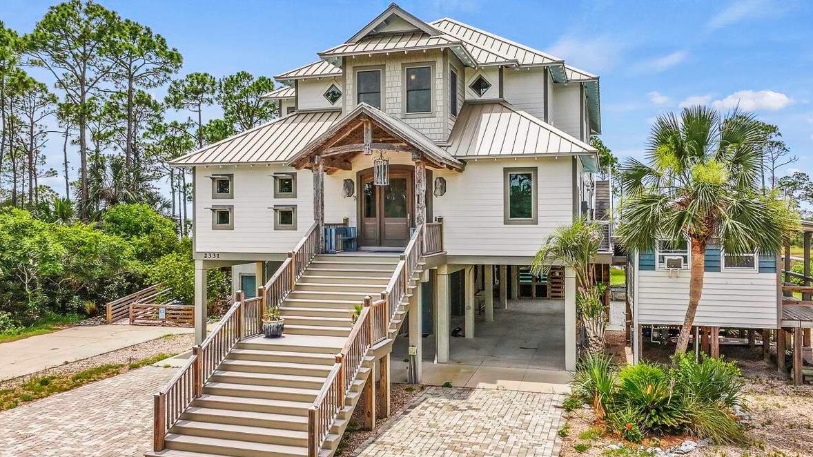 stilt port st. joe home with a staircase leading to its front door