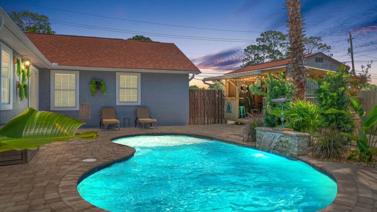 grand lagoon home with a vibrant blue pool in the back grand lagoon home with a vibrant blue pool in the back