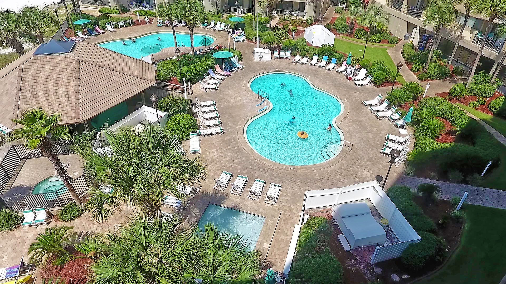 image of an outside hut and two complex shaped pools