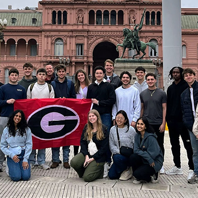 Students pose in front of Casa Rosado in Buenos Aires