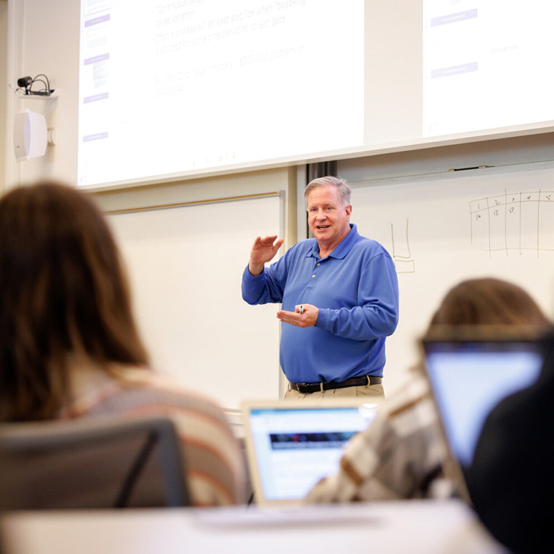 Marty Parker stands at the front of a classroom in the UGA Business Learning Community