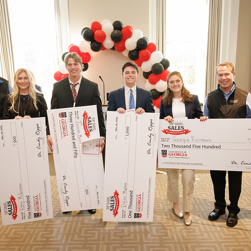 Professional sales students pose with their prize checks. 