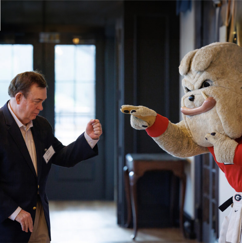 Tony Barnhart prepares to fist bump Hairy Dawg