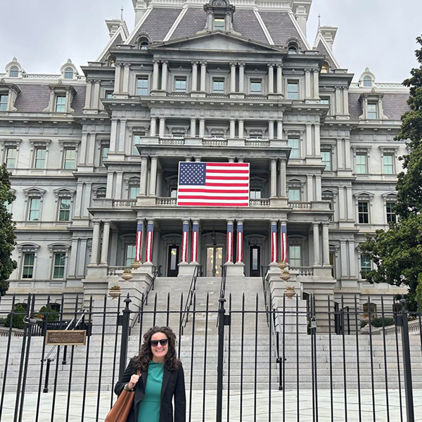 Erin Towery stands in front of  Eisenhower Executive Office Building