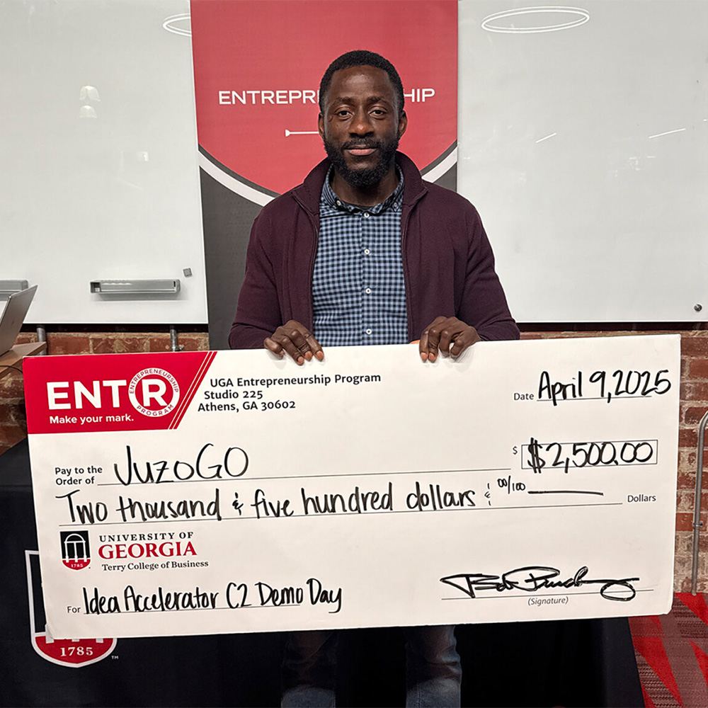 Oge Okolo poses with prize check