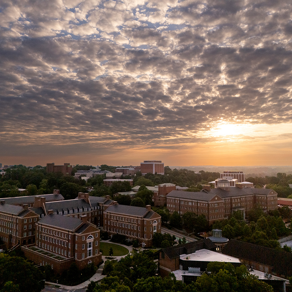 Aerial view of the sunrise over the Business Learning Community, Miller Learning Center and Tate Student Center.