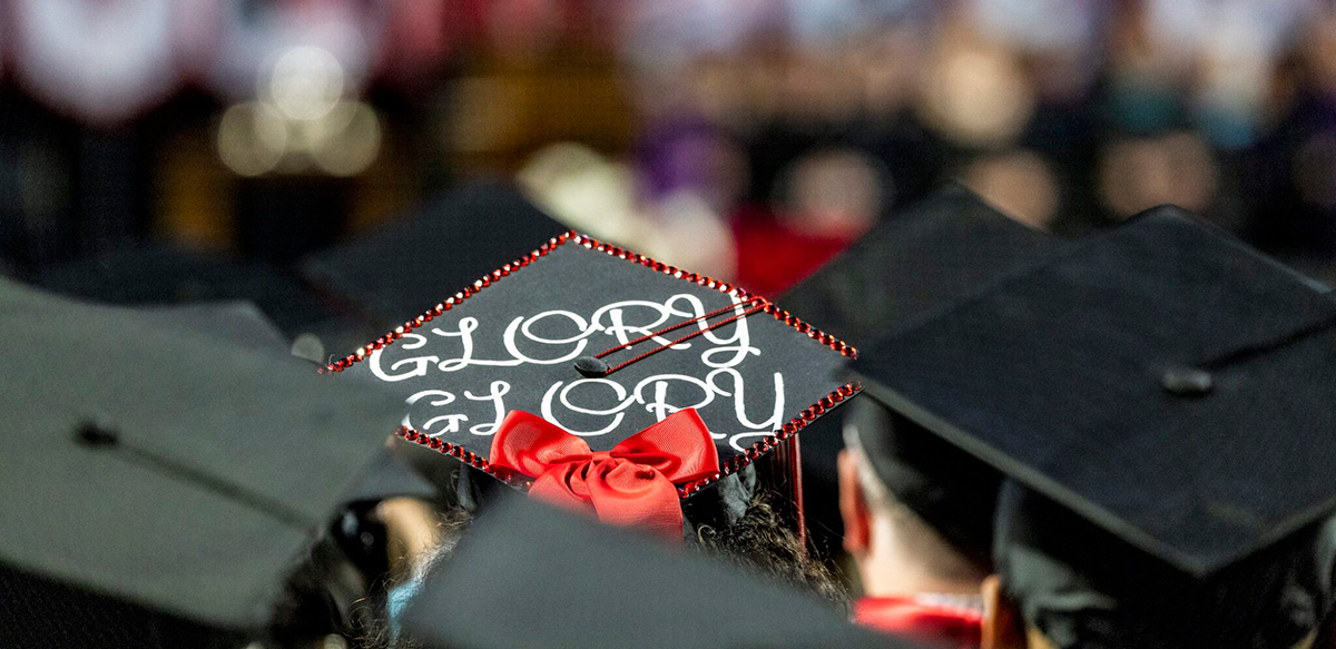 Graduate students celebrate during the fireworks display at the undergraduate Commencement ceremony in Sanford Stadium. (Dorothy Kozlowski/UGA)