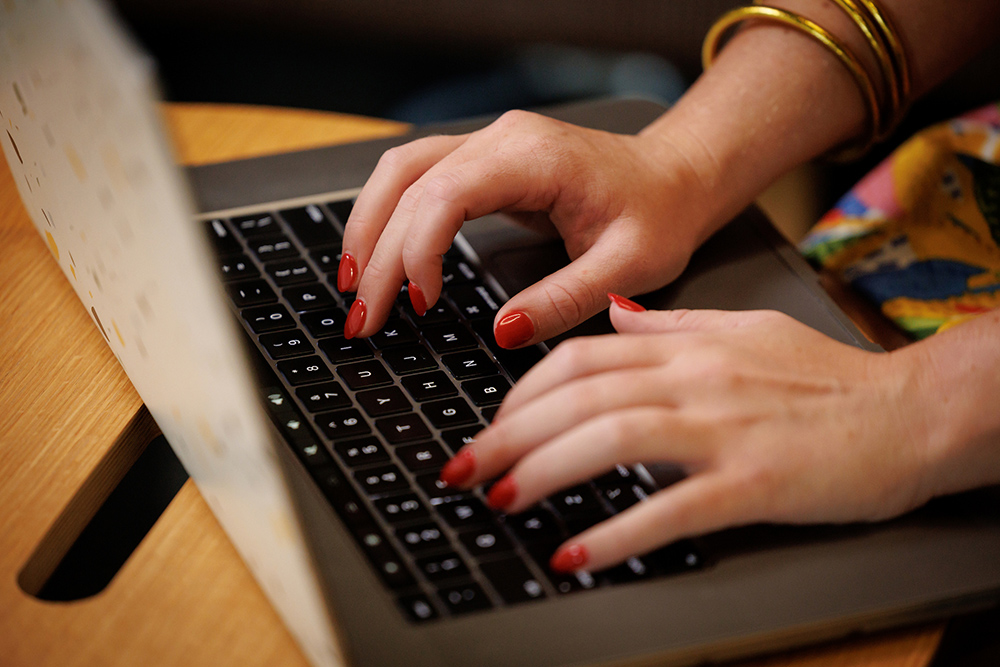 Hands of a woman typing on laptop