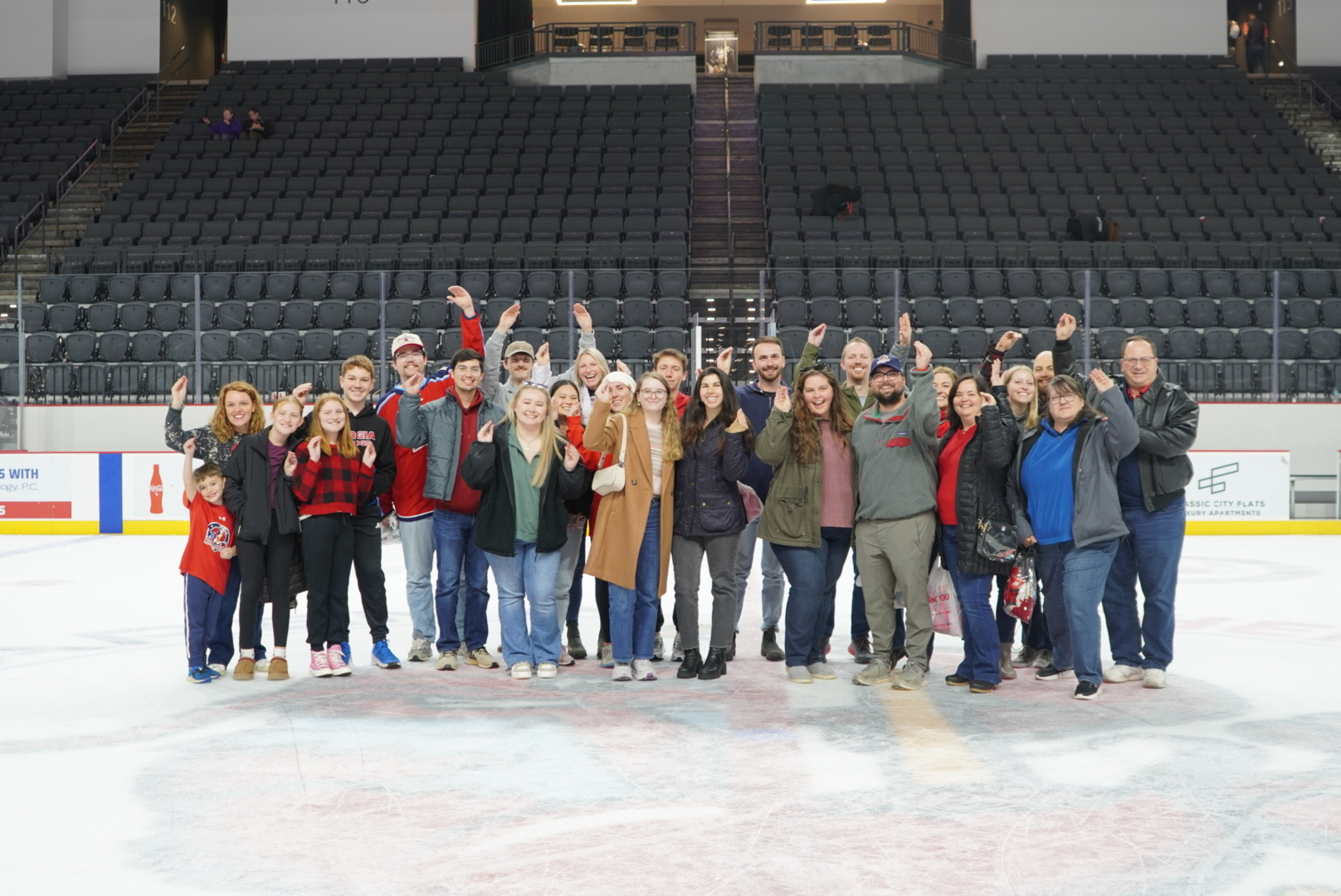 Tull Accounting group poses on an ice rink for a group photo