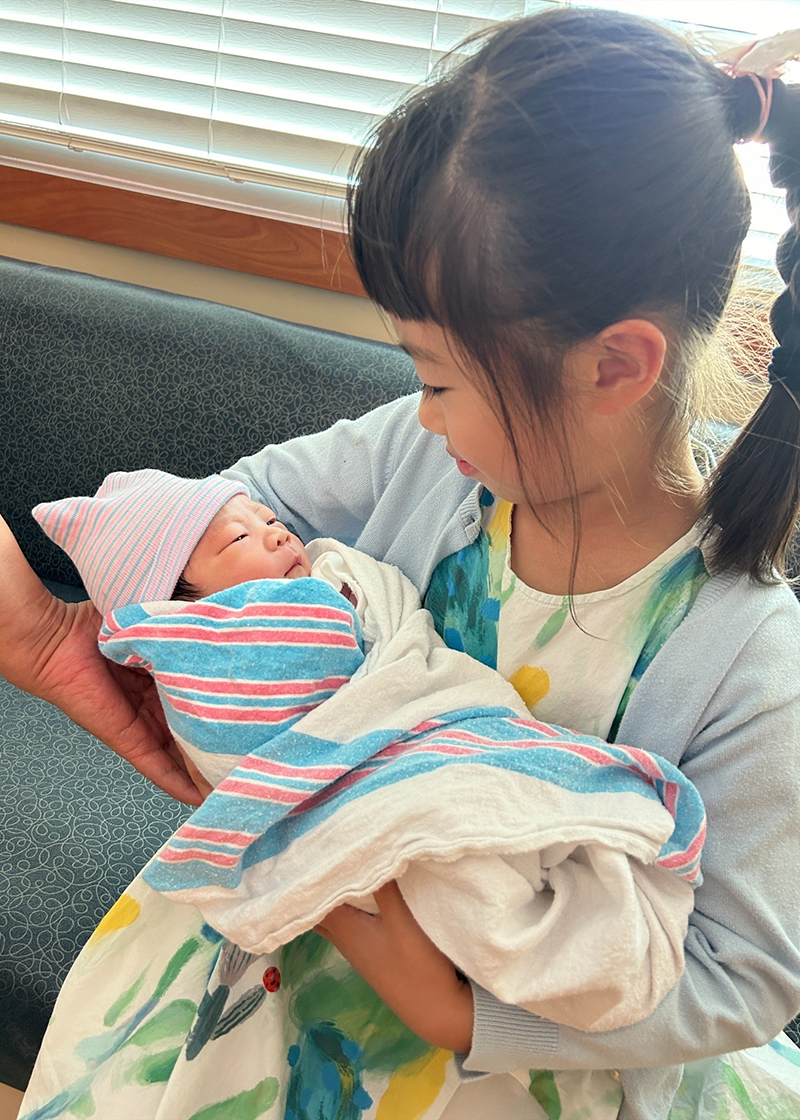 Susan Tangs holds her baby boy, Luca