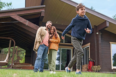 Parents watching boy run into the backyard