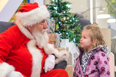 Woman giving a red present to a friend at a holiday party