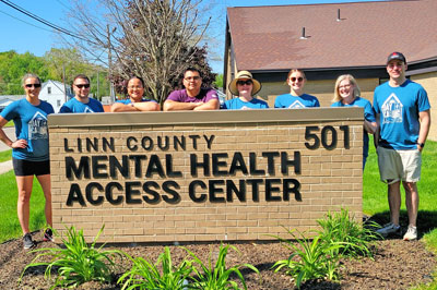 Corda volunteers posing with Linn County Mental Health Access Center sign 