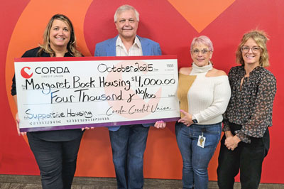 Paula O'Rourke with Margaret Bock Housing employees. Check presentation.