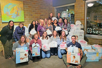 Corda staff with diapers collected for the Eastern Iowa Diaper Bank
