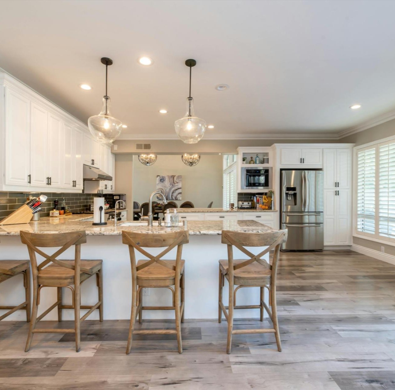 Modern kitchen with laminate flooring installed by Tile Zone — affordable, durable, and stylish flooring solutions for Houston homes and businesses